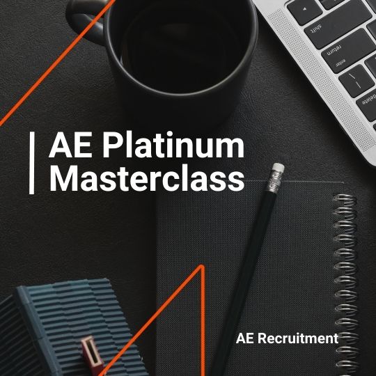 Flat lay of a workspace with a coffee cup, notebook, pencil, and laptop. White text reads “AE Platinum Masterclass” with AE Recruitment branding.